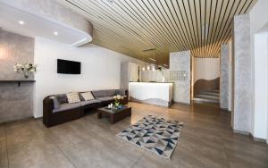 a living room with a couch and a tv at Hotel Miramare in Marotta