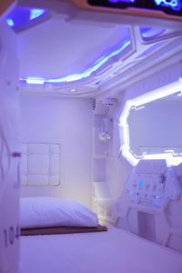 a room with a bed in a room with lights at The Capsule Malioboro in Yogyakarta