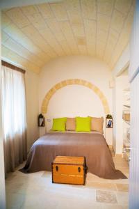 a bed with green pillows and a chest in a room at Villa Vittoria in Cisternino +63 photos