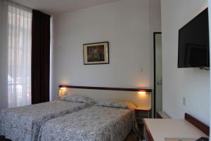 Postel nebo postele na pokoji v ubytování Hôtel Royal