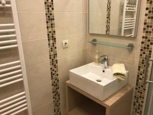 a bathroom with a white sink and a mirror at Apartments Jani in Hvar