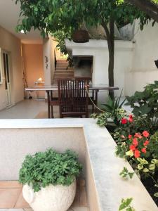 a garden with a table and a tree and flowers at Apartments Jani in Hvar