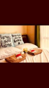 a bed with two towels and pillows on it at NEW SERIN Studio Condo w/pool-WIFI/NETFLIX/SPOTIFY in Tagaytay