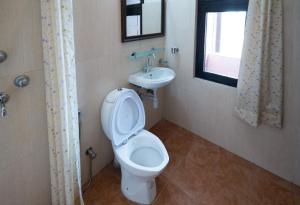 a bathroom with a toilet and a sink at Planet Bhaktapur Hotel in Bhaktapur