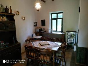 a dining room with a table and some chairs at Darutollas Vendégház in Ópusztaszer