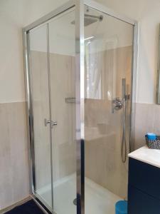a shower with a glass door in a bathroom at Casa Cote in Chiessi