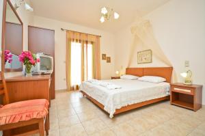 a bedroom with a bed and a tv in it at Anthi Studios in Agia Anna Naxos