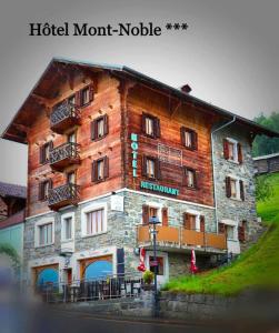 a large wooden building with balconies on it at Hotel Mont-Noble in Nax