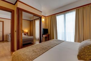 Ένα ή περισσότερα κρεβάτια σε δωμάτιο στο iH Hotels Roma Cicerone