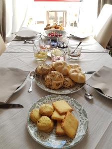 a table topped with plates of bread and pastries at Locanda Elena in Equi Terme