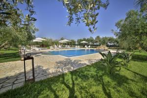 a swimming pool in the middle of a yard at Terra dei Sogni in Torre Lapillo