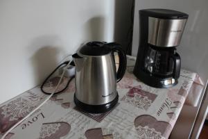 a coffeemaker and a coffee maker on a table at B&B Airport Venice Diego 2 in Tessera