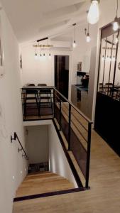 a room with a staircase with a table and a kitchen at Le point d'Orgue - Gagnant du Prix de la critique voyageur 2023 - vivez la Provence à votre rythme in LʼIsle-sur-la-Sorgue