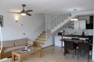 a living room with a couch and a table at Casa Feliz en el complejo Las Fresas in Puerto Rico de Gran Canaria