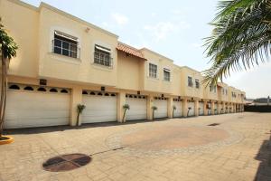 a building with two garage doors and palm trees at Motel Mirage in Guadalajara