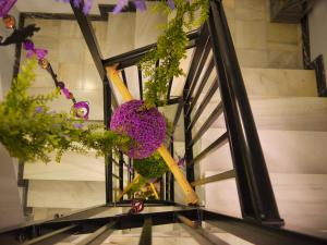 a bunch of flowers hanging from a stair case at Hotel Maravillas del Mundo in Calpe