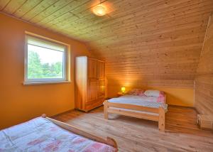 1 dormitorio con 2 camas en una cabaña de madera en Domki w Smolniku z możliwością apiterapii, en Komańcza