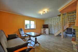 a living room with a couch and a table at Domki w Smolniku z możliwością apiterapii in Komańcza