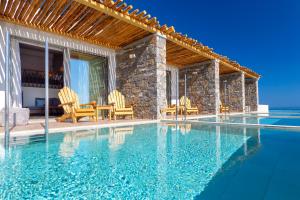 a villa with a swimming pool and a patio at Atermono Boutique Resort & Spa in Platanes