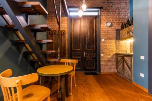 a room with a table and chairs and a brick wall at 3 Heritage Rooms in Tbilisi City