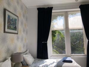 a bedroom with a bed and a window at 26 Belvidere Crescent Apartment in Aberdeen