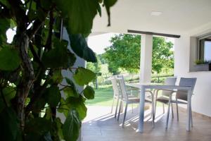 Biały stół i krzesła na patio w obiekcie NA OFF w mieście Radenci