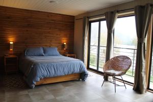 מיטה או מיטות בחדר ב-BancoArena Hotel - Refugio Ribera