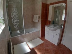 a bathroom with a tub and a sink and a shower at Edenvale Bed & Breakfast in Portnoo +16 photos