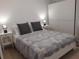 a bedroom with a large bed with two night stands at Apartment Star Danica*** in Šibenik