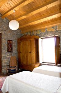 a bedroom with a bed and a window and a chair at Casa Batia in Cefalù