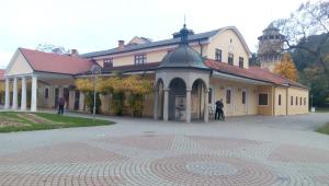 a large building with a clock tower in the background at Dobre ubytovanie in Piešťany
