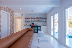 
a living room filled with furniture and a window at Hotel California Urban Beach - Adults Only in Albufeira

