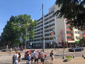 a group of people waiting to cross a street at Apartament Skwer Gdynia in Gdynia