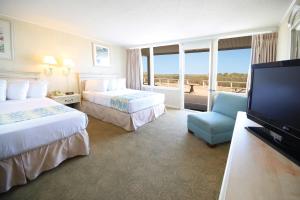 a hotel room with two beds and a flat screen tv at Seabonay Oceanfront Motel in Ocean City