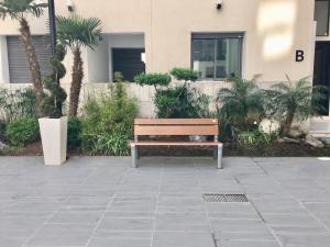 a wooden bench sitting in front of a building at Appartement Miramar in Mohammedia
