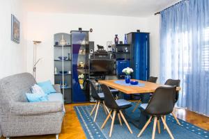 a living room with a table and a chair at Apartman GROMILA in Senj