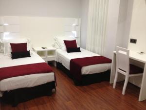 A bed or beds in a room at Hotel Pepo