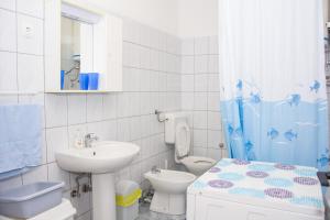 a bathroom with a sink and a toilet and a shower at Apartman GROMILA in Senj +41 photos