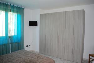 a bedroom with a large cabinet with a television on it at Villa Flora in Perugia