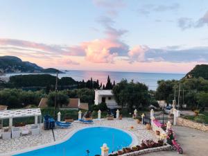 a view of a swimming pool and the ocean at Fotini Studios in Paleokastritsa