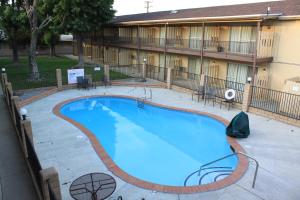 a large swimming pool in front of a building at Menifee Inn in Menifee