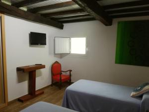 A bed or beds in a room at Casa Xestadelo