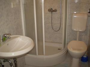 a bathroom with a sink and a shower and a toilet at Apartment Smil - 30 m from sea in Sućuraj