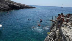 a group of people swimming in a body of water at STERNES house in Agios Leon