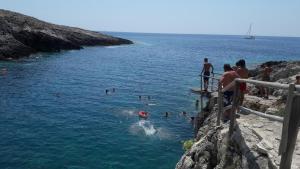 a group of people swimming in a body of water at STERNES house in Agios Leon