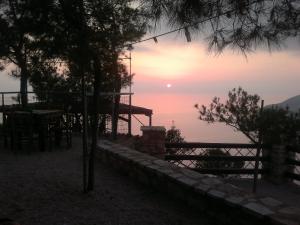 a view of the sun setting over the water at STERNES house in Agios Leon