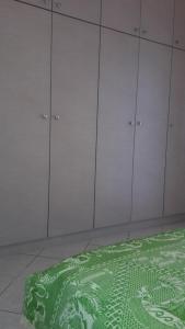 a room with white hangers and a green rug at STERNES house in Agios Leon