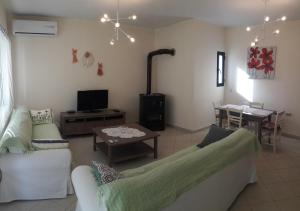 a living room with a couch and a table at STERNES house in Agios Leon