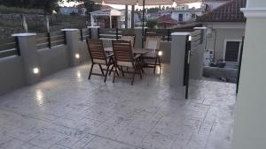 a patio with chairs and a table on a balcony at STERNES house in Agios Leon