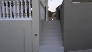 a staircase leading up to a house with white walls at STERNES house in Agios Leon